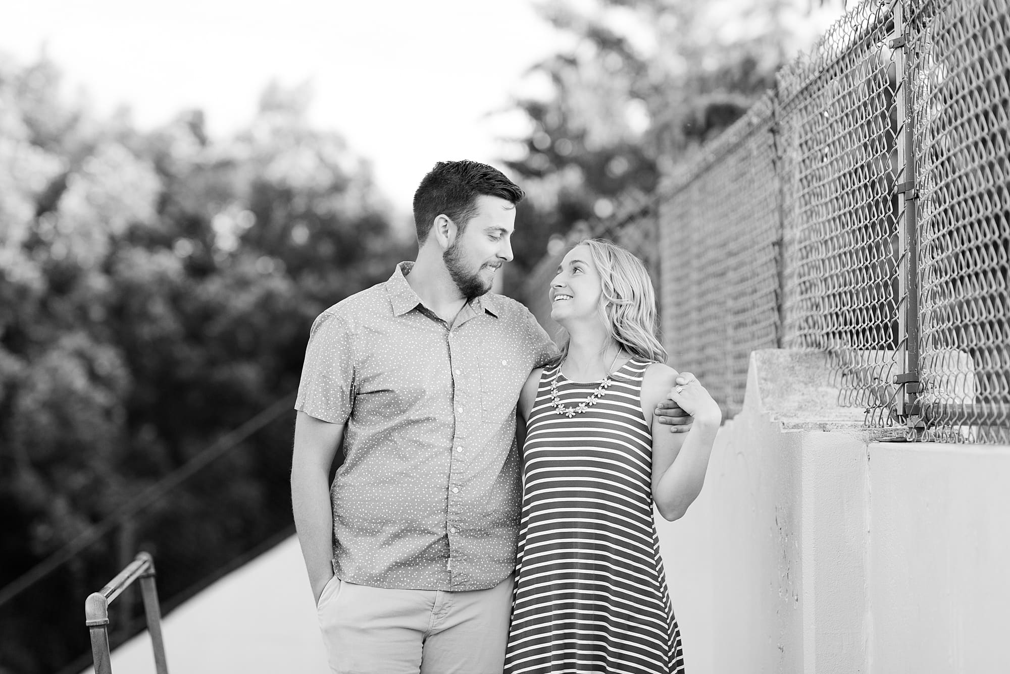 Couple look at each other at the top of the stairs in Island Park during their engagement session