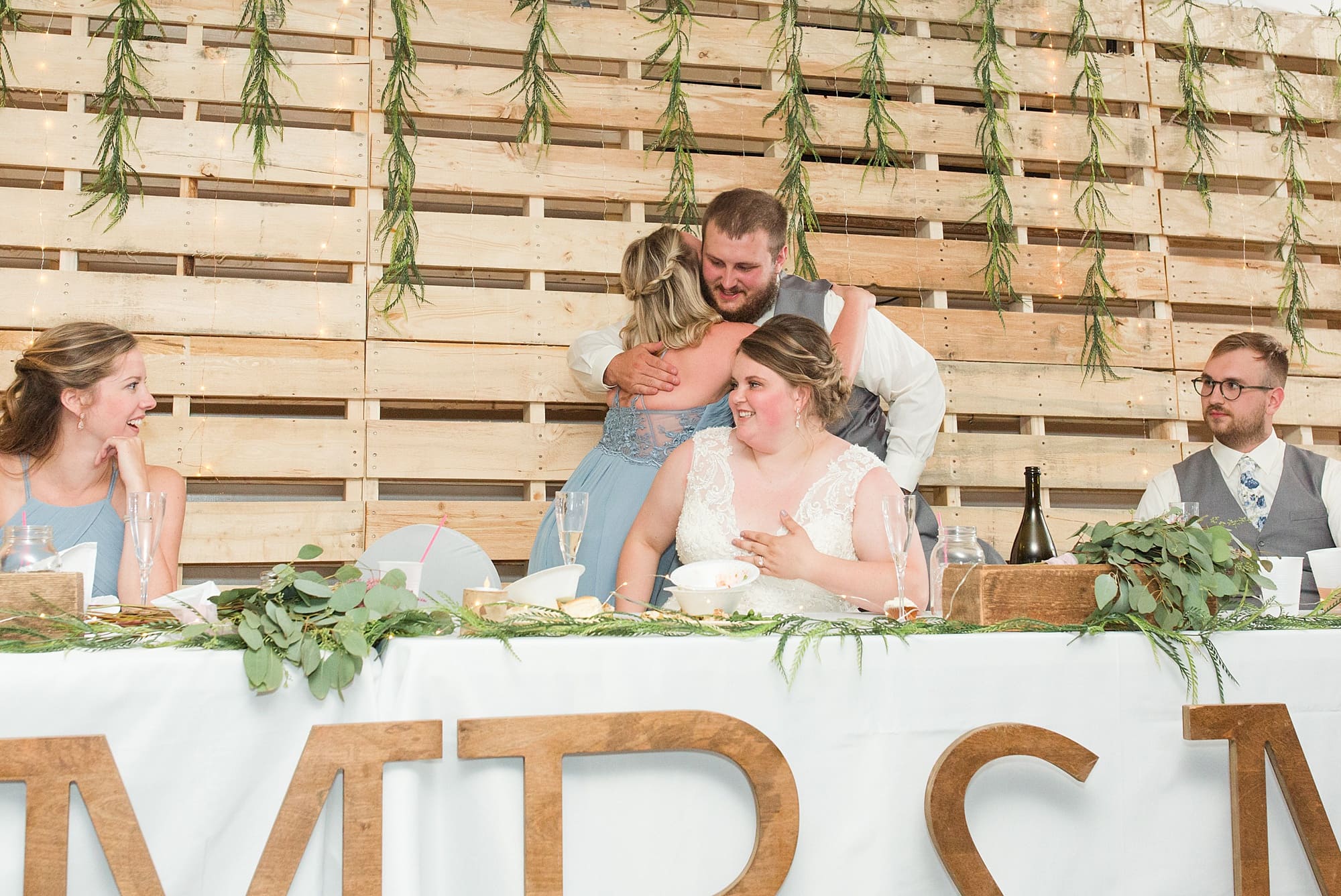 Groom hugs the maid of honor after her speech at Wedding Reception at Bemidji Eagles