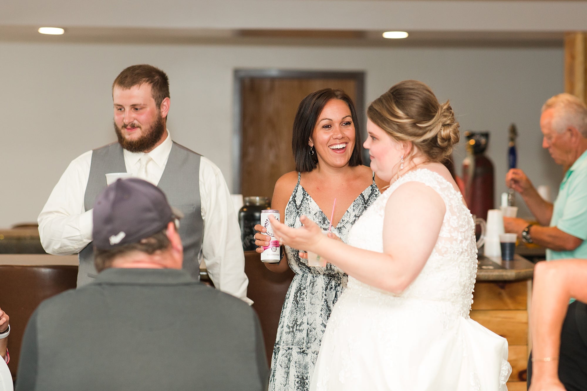 Bride and Groom talk with guests at their Wedding Reception Bemidji Eagles