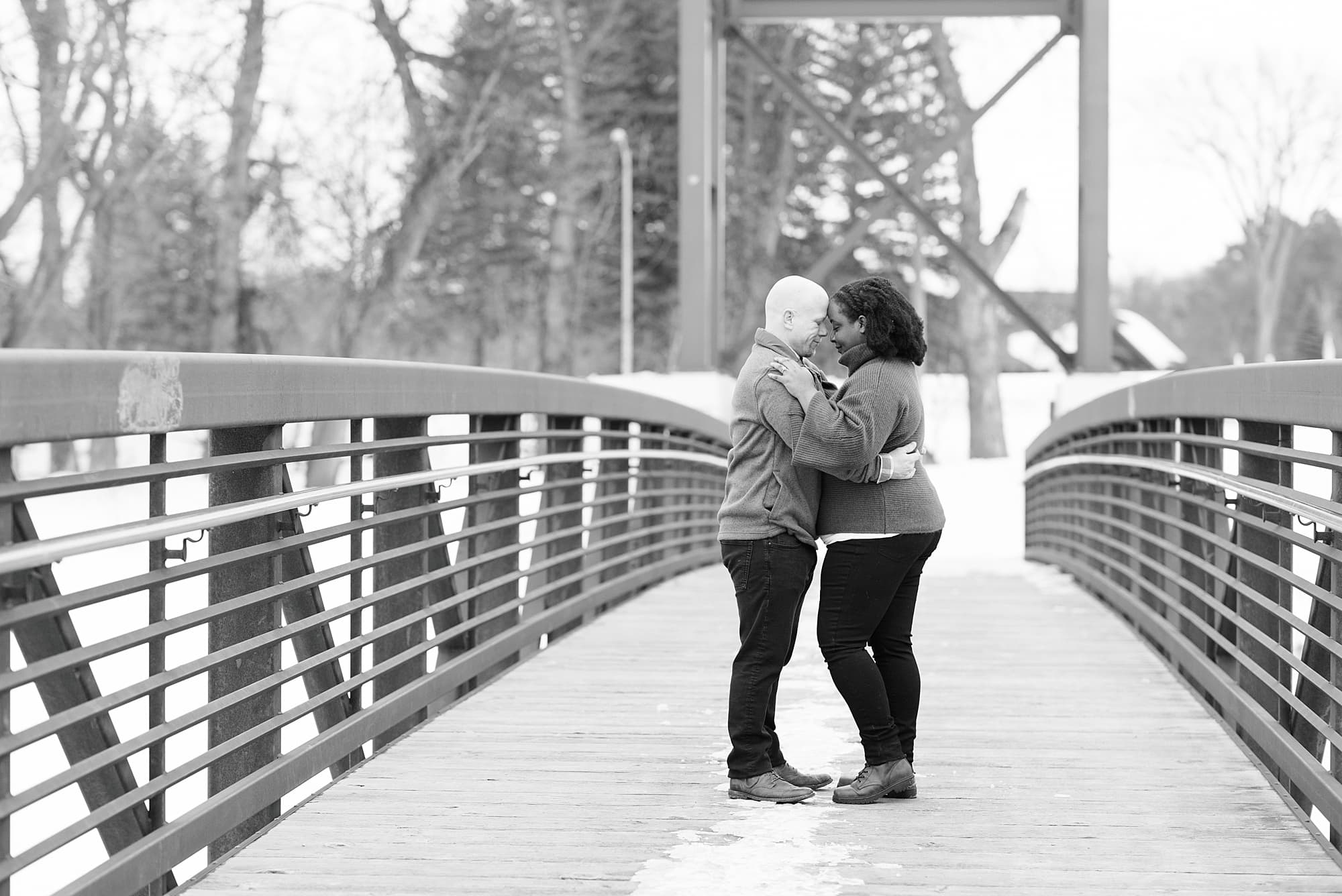 Black and white photo of an engaged couple during their winter engagement session in Lindenwood Park