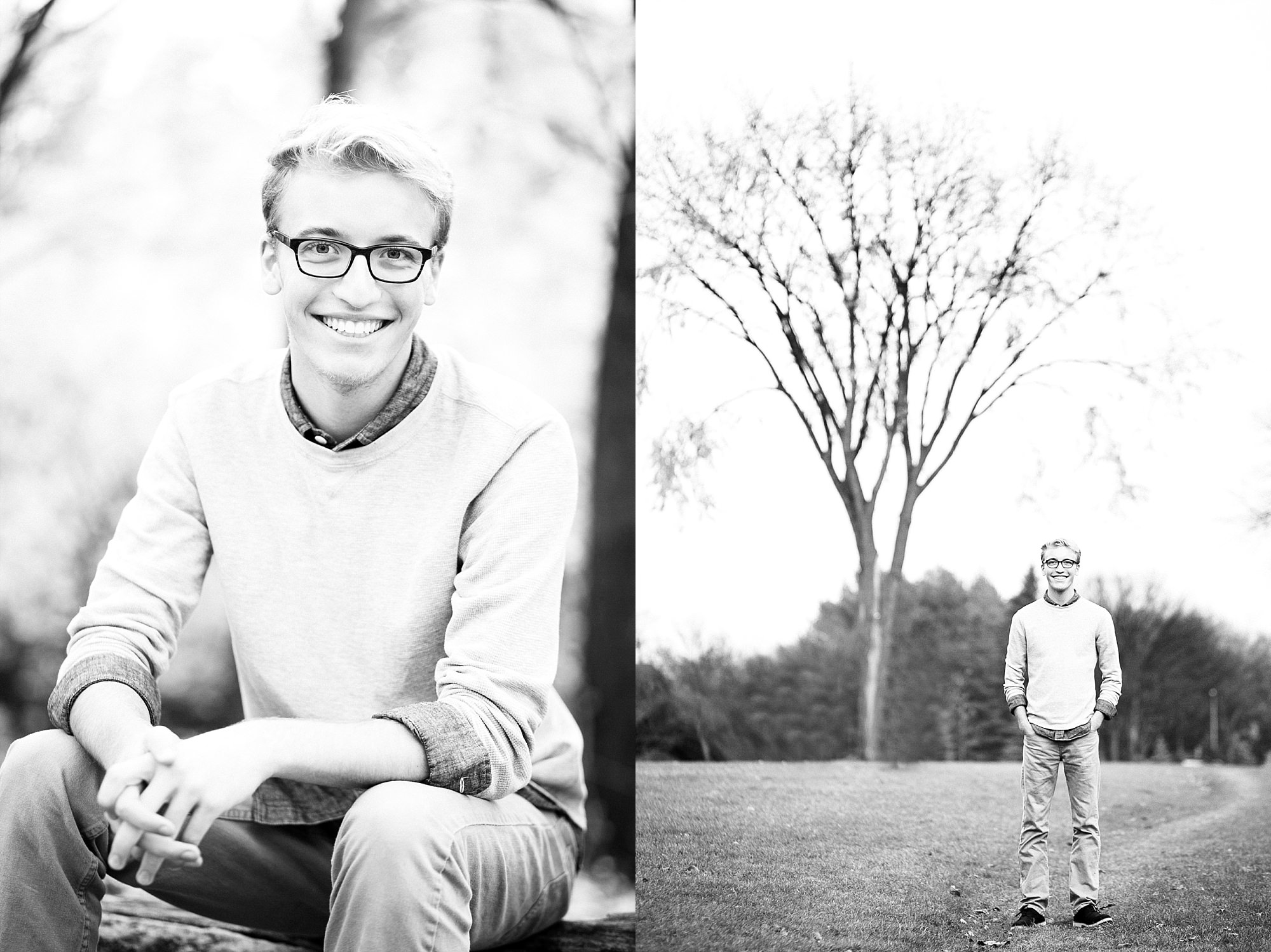 Senior in grey sweater and black glasses stands in front of a large, lone tree in Lindenwood park