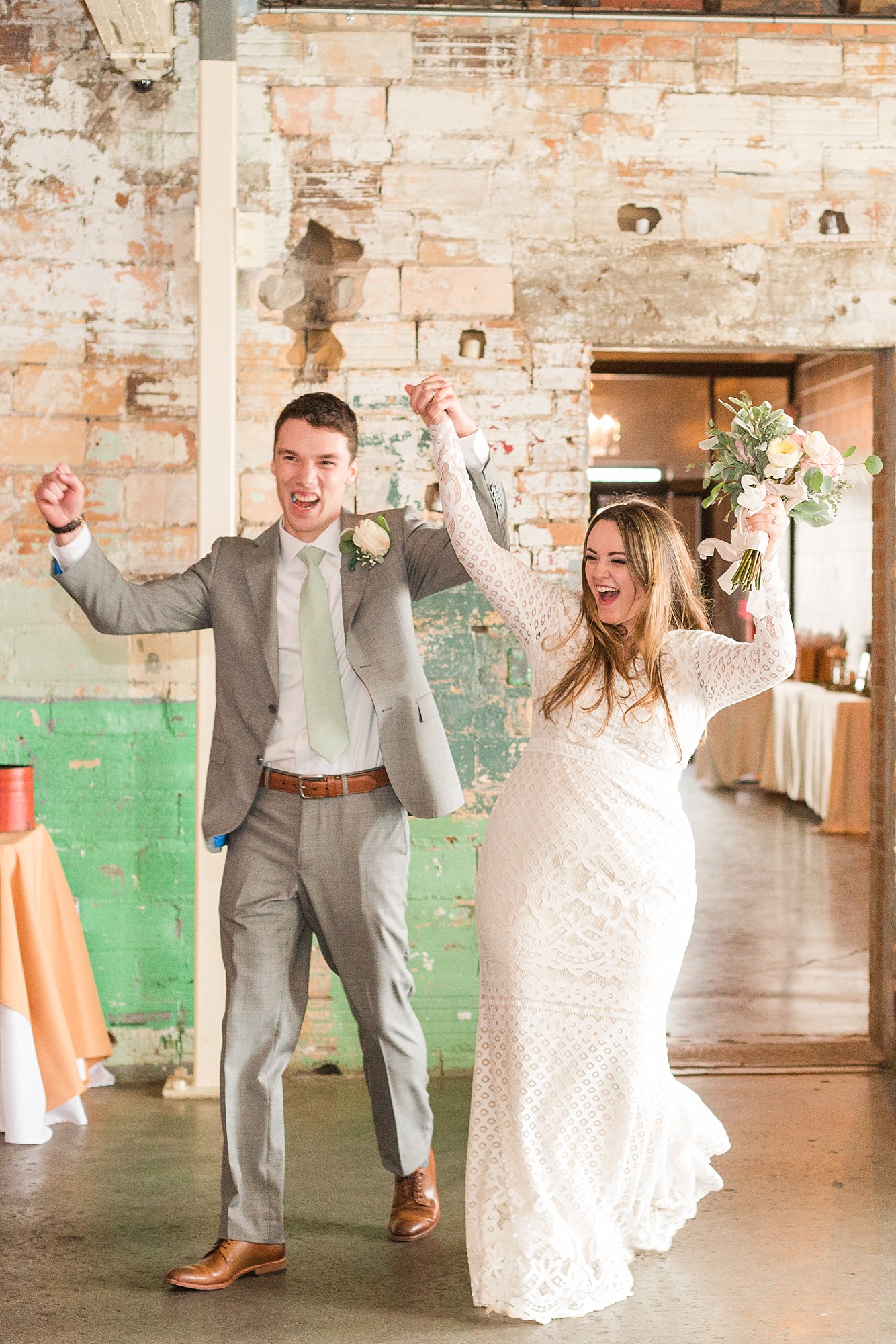 A newlywed couple dances into their wedding reception