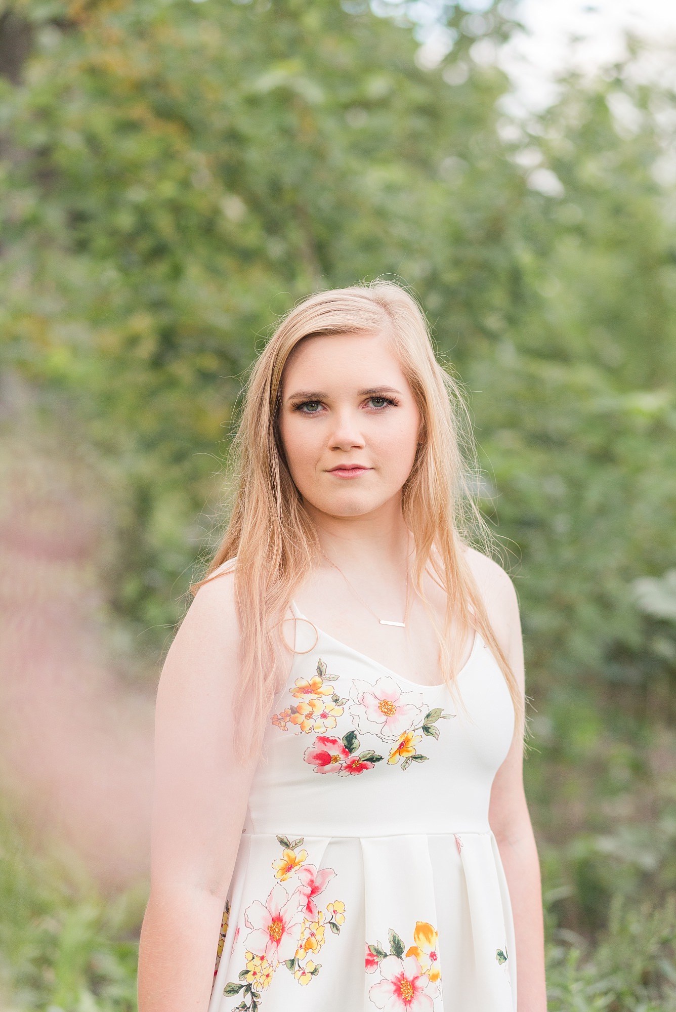 Blonde high school senior stares into the camera during her Senior Portraits in Fargo
