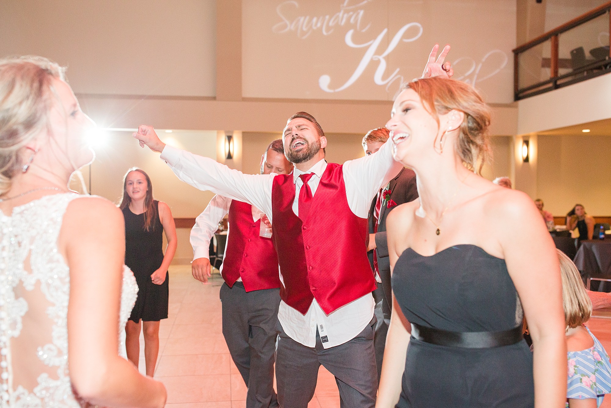 Guests dance the night away at this red and black Glamorous Wedding at the Avalon