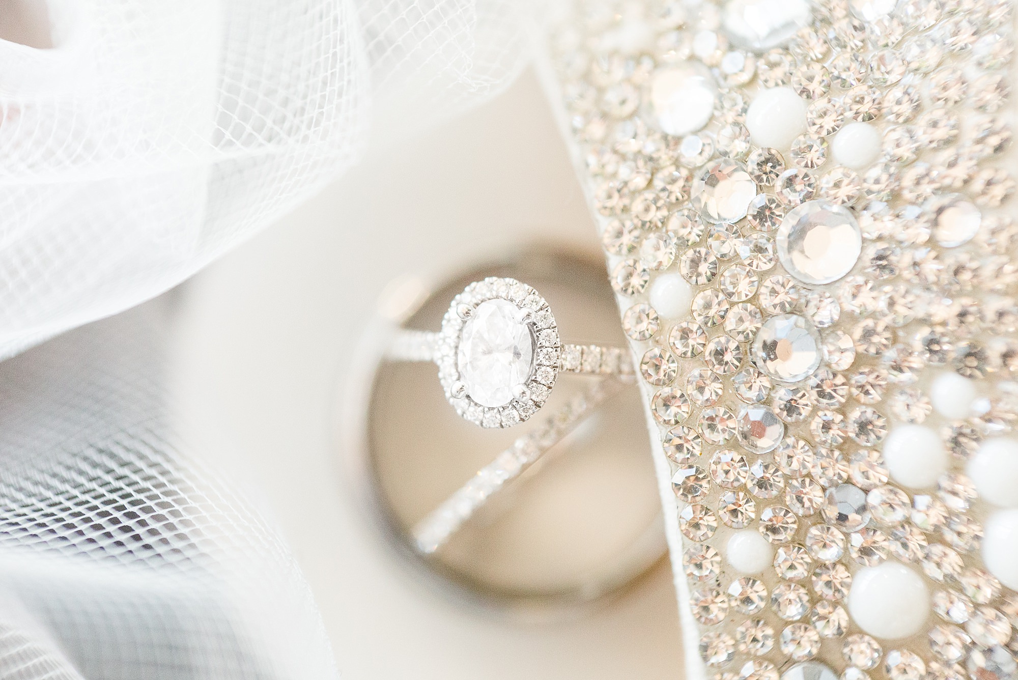 Wedding day details with diamond ring with a halo and sparkly shoes. 