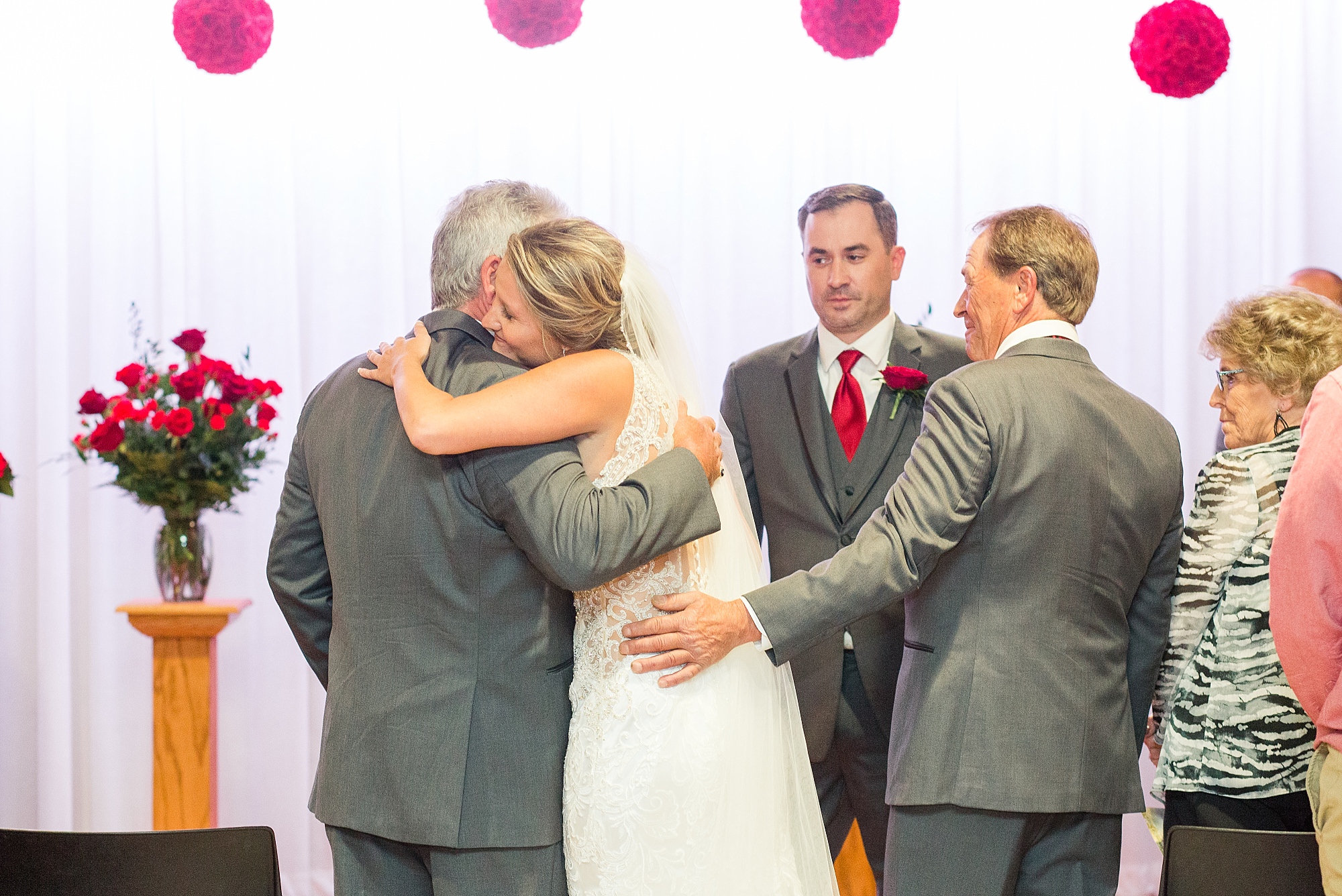 A bride hugs her two father's during her Glamorous Wedding at the Avalon
