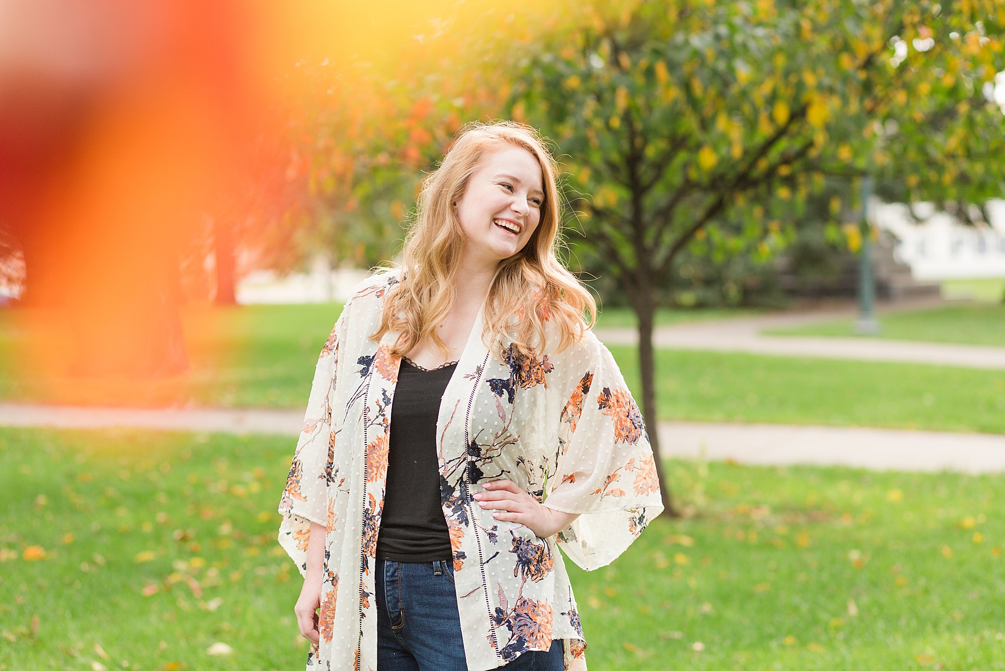Senior laughs over her shoulder during her fall senior photos