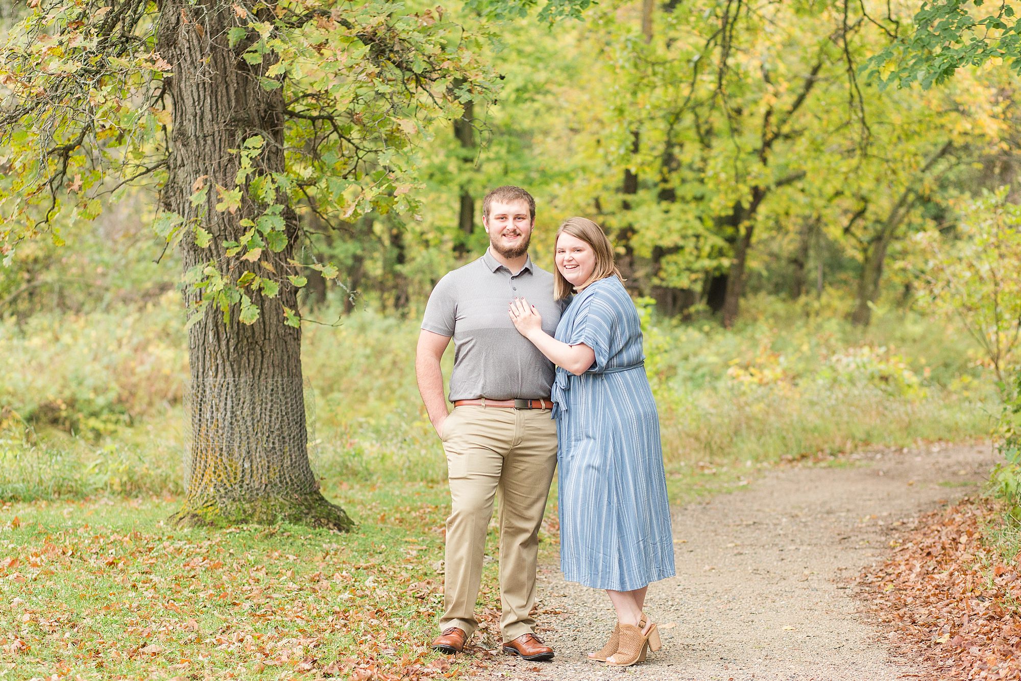 A couple in shades of blue and greys pose in front of the fall colors in Buffalo River State Park