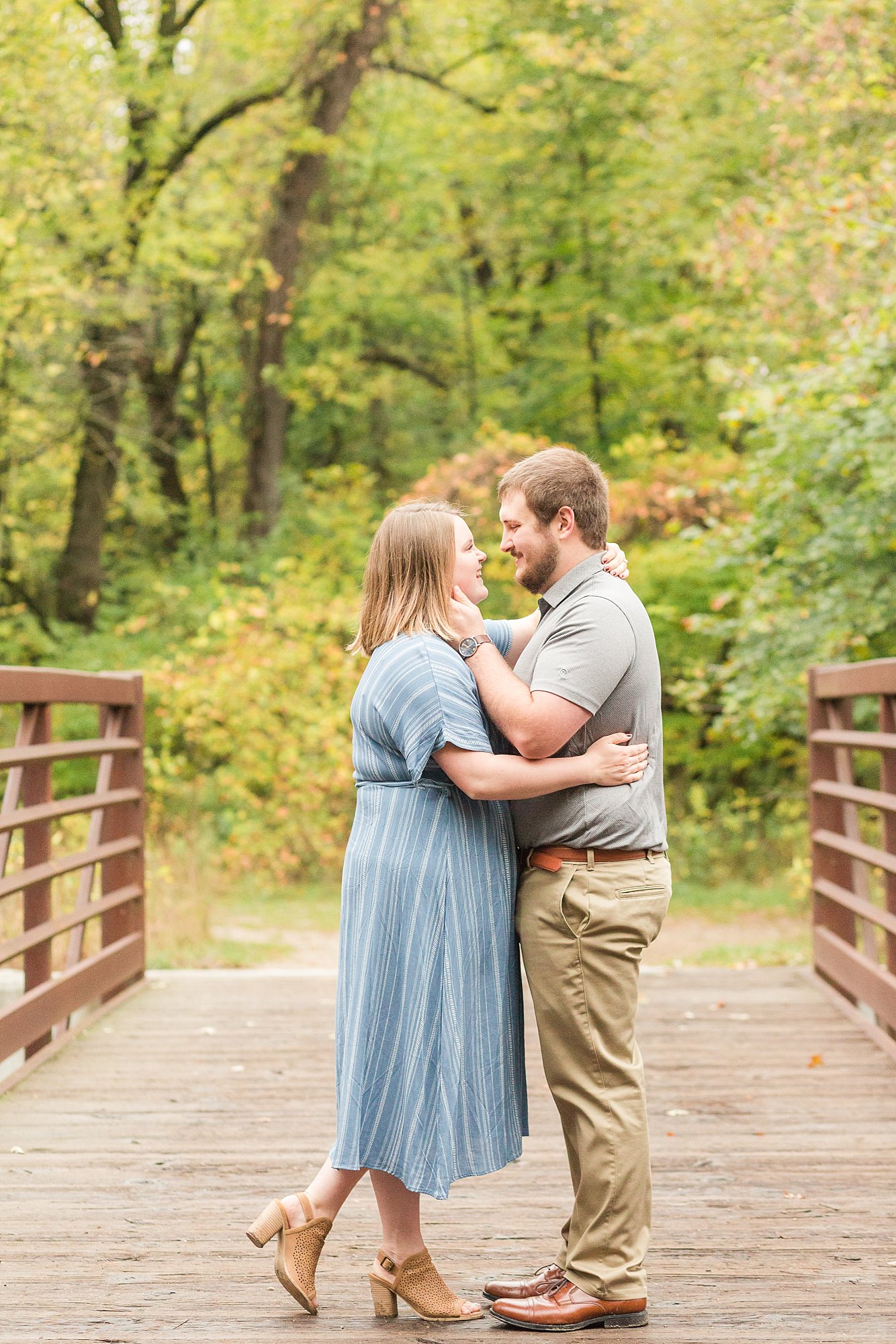 An engaged couple stands on the Buffalo River State Park bridge
