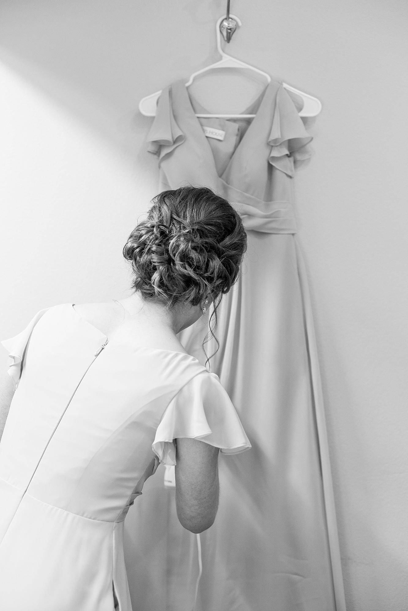 A Bridesmaid steams her dress at the beginning of the wedding timeline