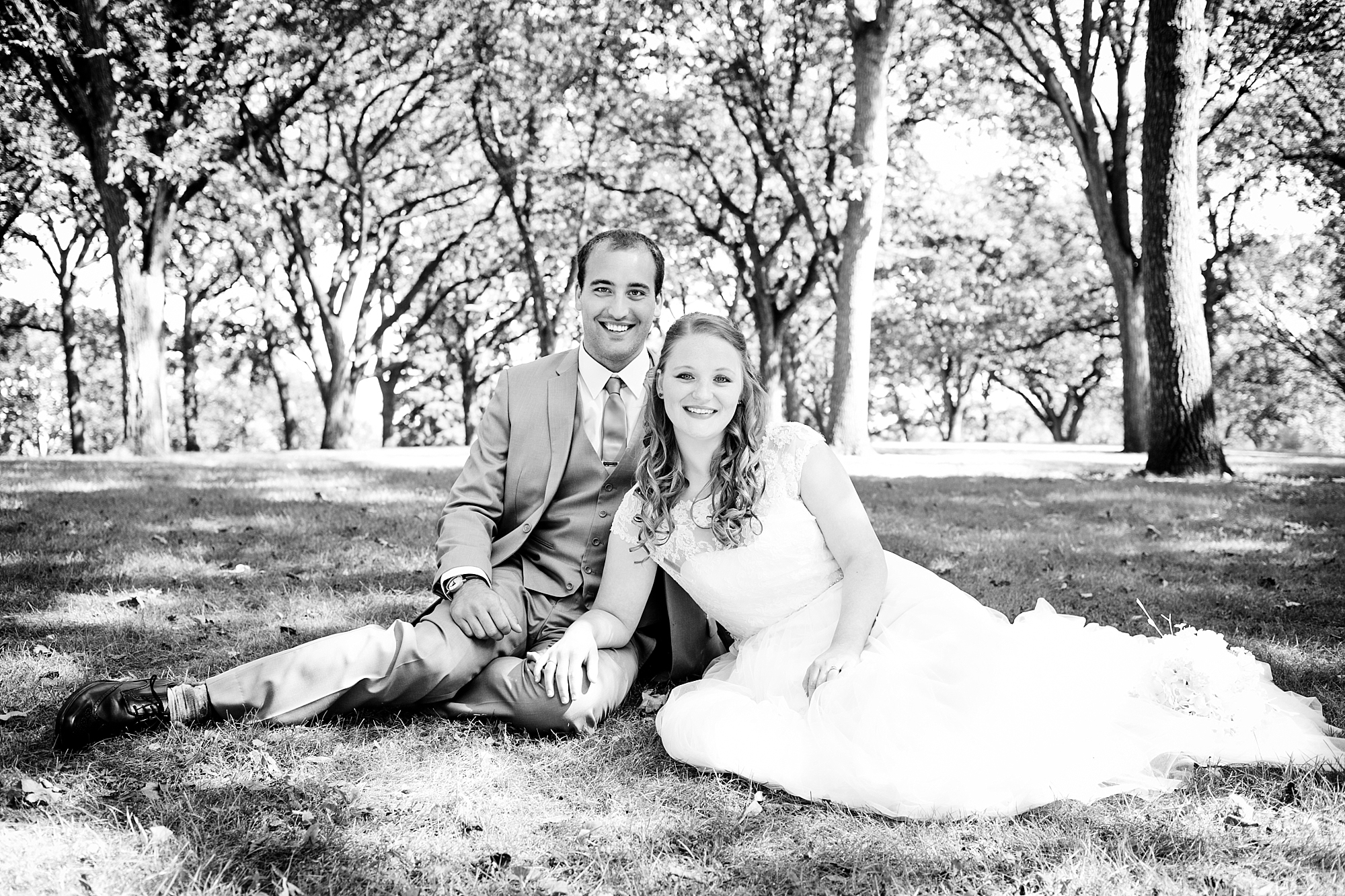 Bride and Groom sitting in Island Park