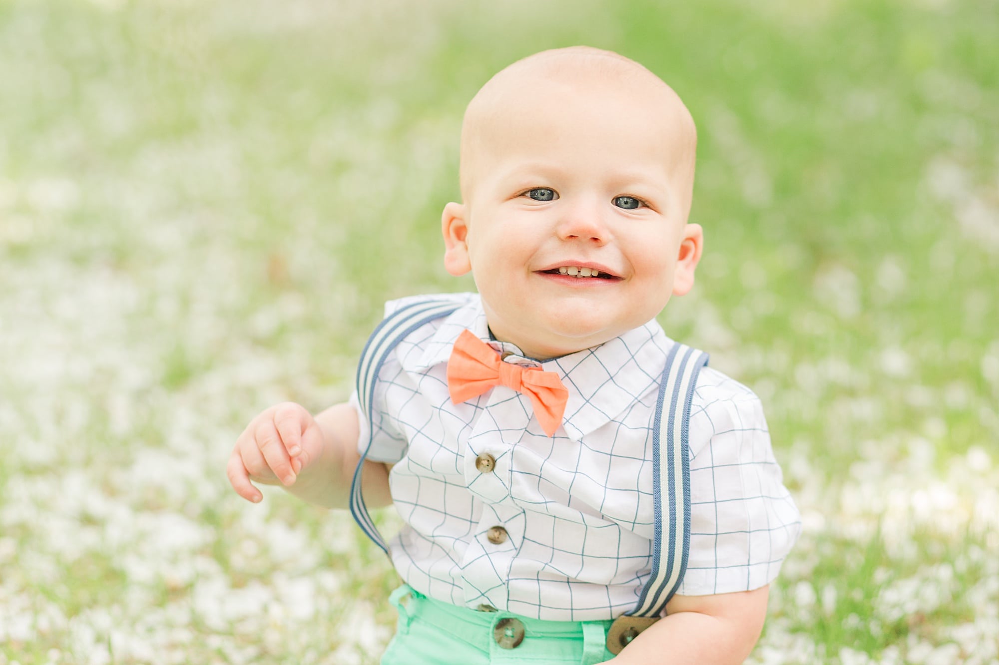 Toddler smiling during his one year old session in Fargo