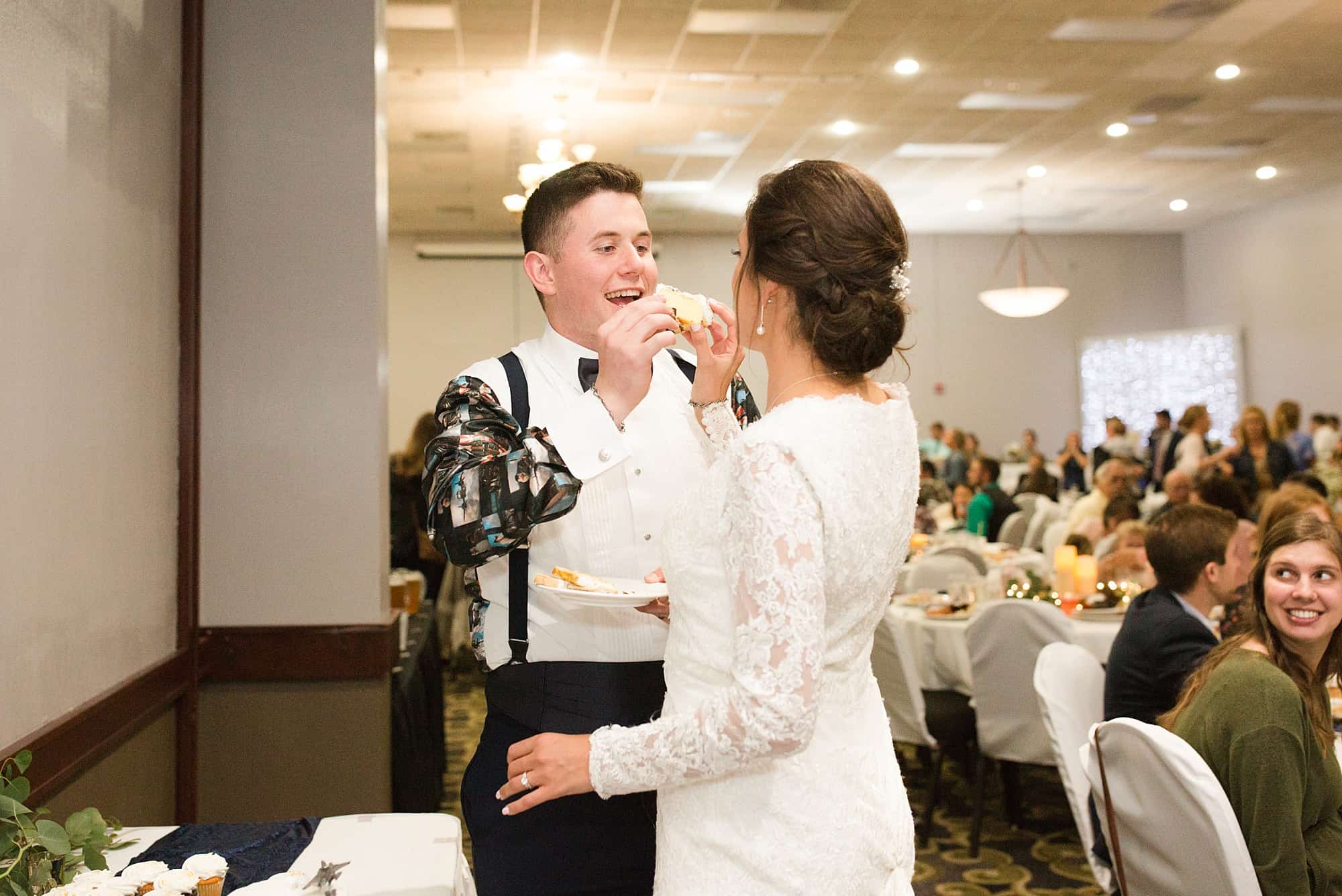 A groom wears a party shirt after his outfit change for his wedding reception