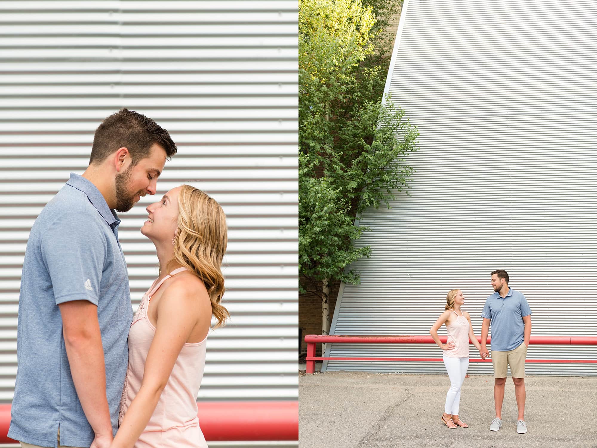 Engaged couple pose in front of a large metal wall with a tree in Downtown Fargo