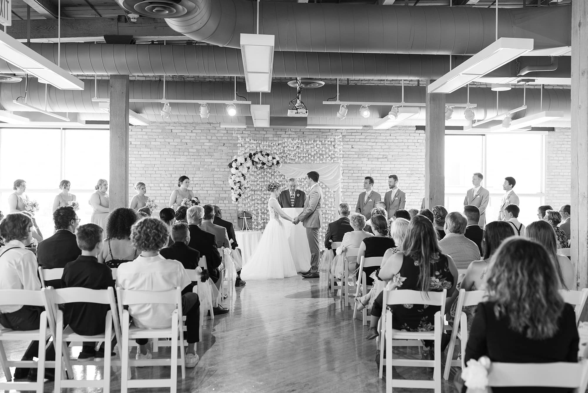 Black and white photo of wedding ceremony at the Plains Art Museum
