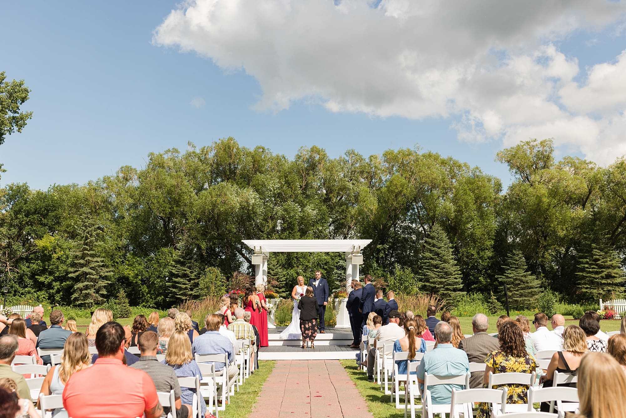 Bride and Groom during their outdoor wedding ceremony on the lawn at Naastad Acres