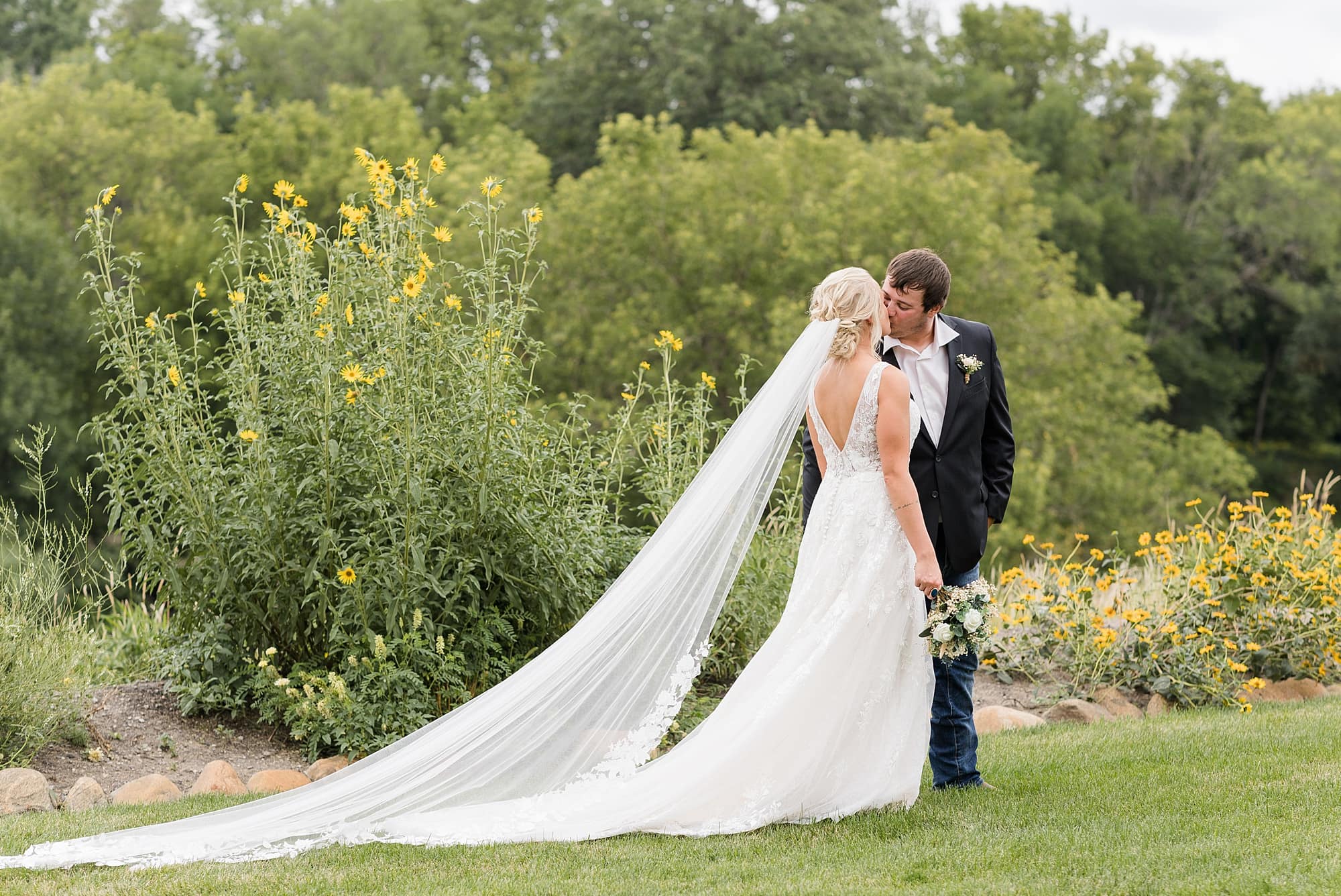 Bride and Groom kiss during their photo session at Rustic Oaks