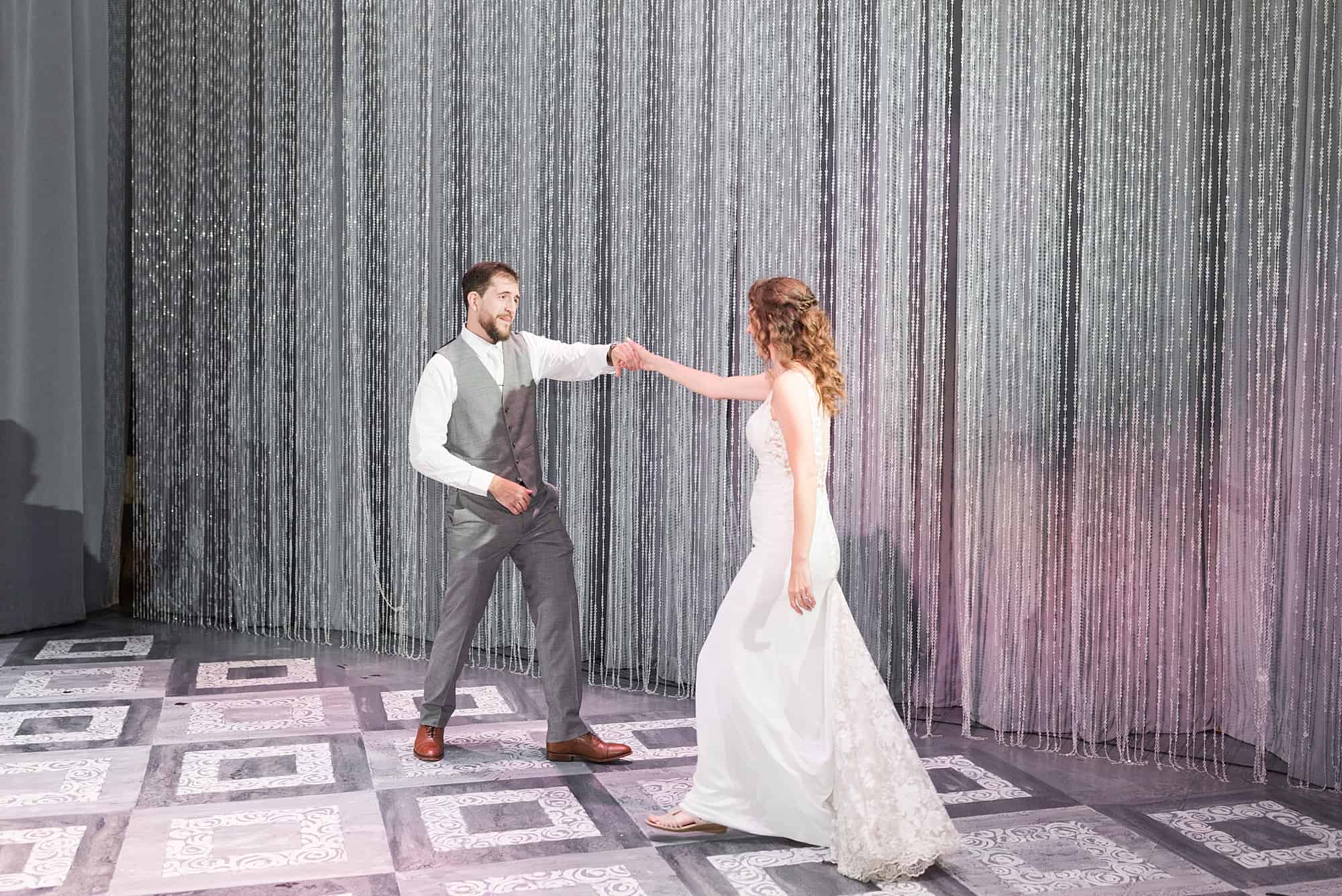 Bride and groom share their first dance no the stage at the Chanhassen Dinner Theater