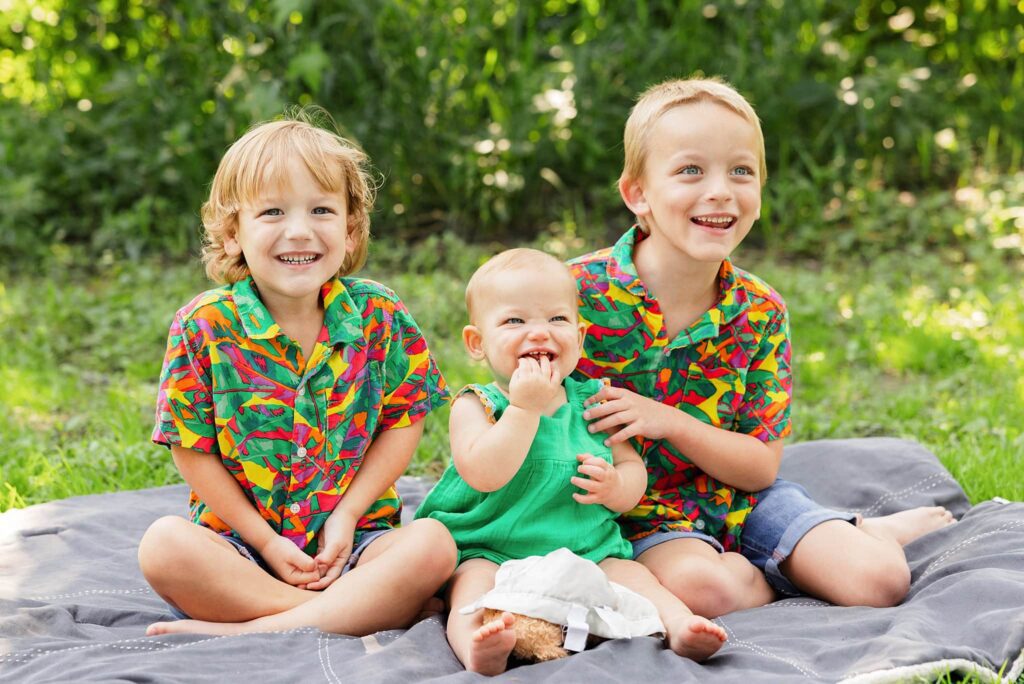 three young kids in bright colors for family photos in Lindenwood Park